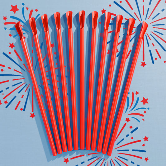 Red plastic spoon straws fanned out on a blue background with red and blue starburst designs.