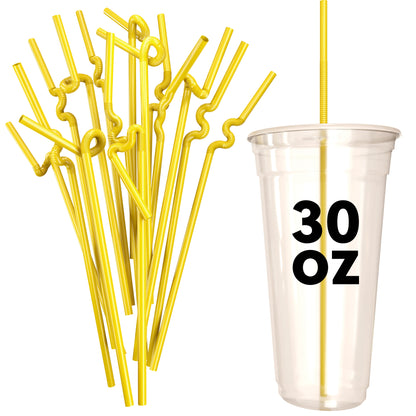 Yellow extra flexible art straws with twists beside a clear 30 oz plastic cup
